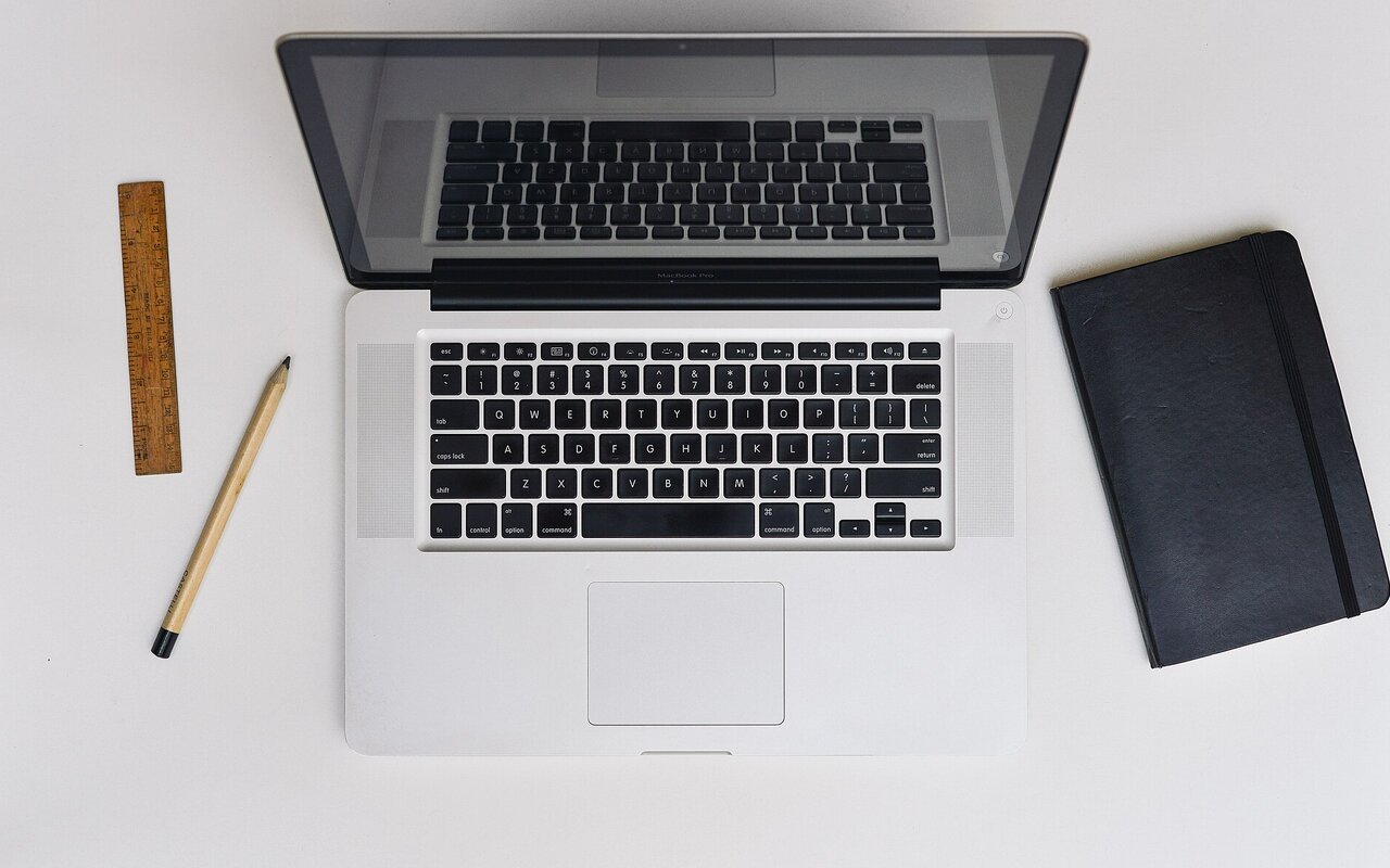 MacBook Pro positionné sur un bureau avec accessoires Apple