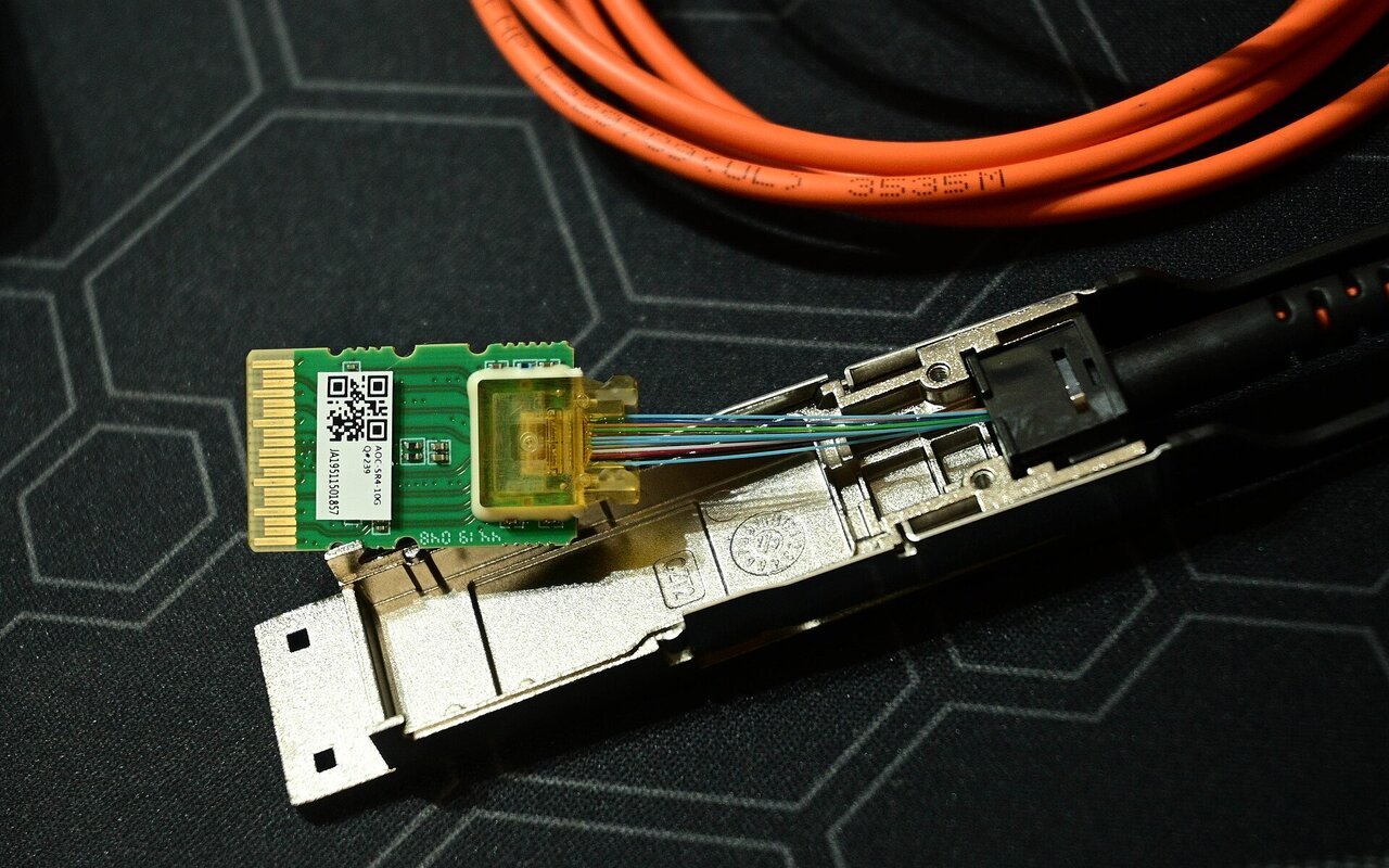 Transcepteur QSFP démonté montrant composants électroniques et optiques.