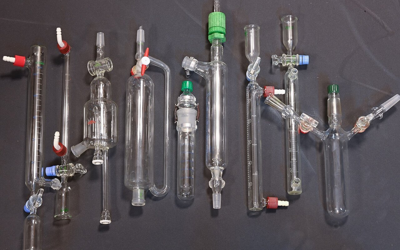 Assortiment de verrerie de laboratoire incluant béchers, fioles et autres récipients en verre transparent